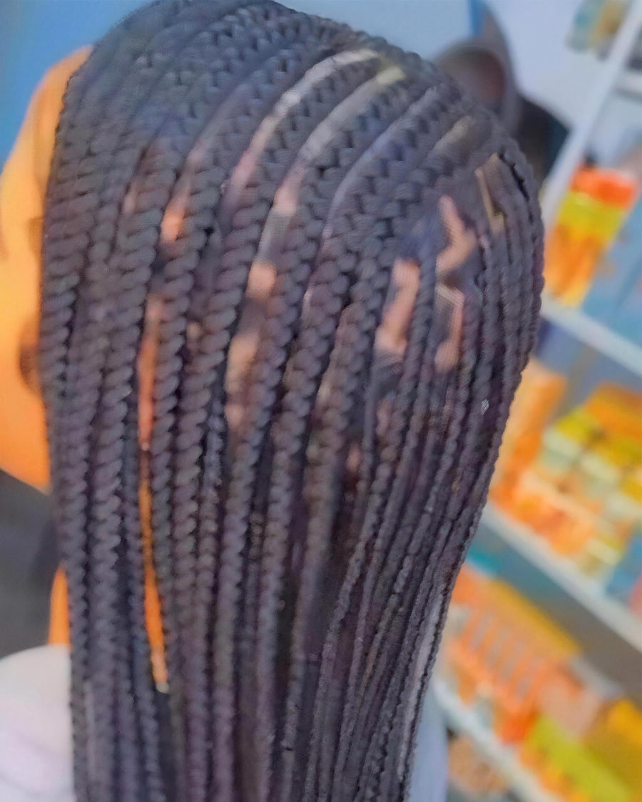 Knotless braids with a shaped parting design, side view